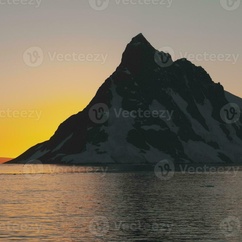 Lemaire strait coastal landscape, mountains and icebergs, Antarctic Peninsula, Antartica. photo