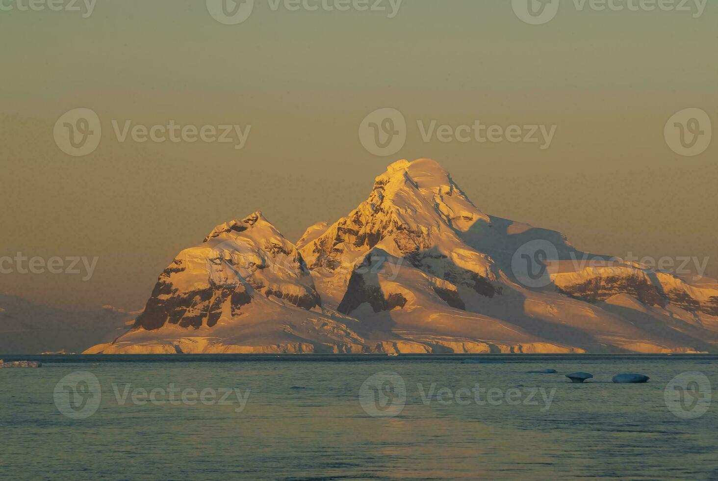 Lemaire strait coastal landscape, mountains and icebergs, Antarctic Peninsula, Antartica. photo