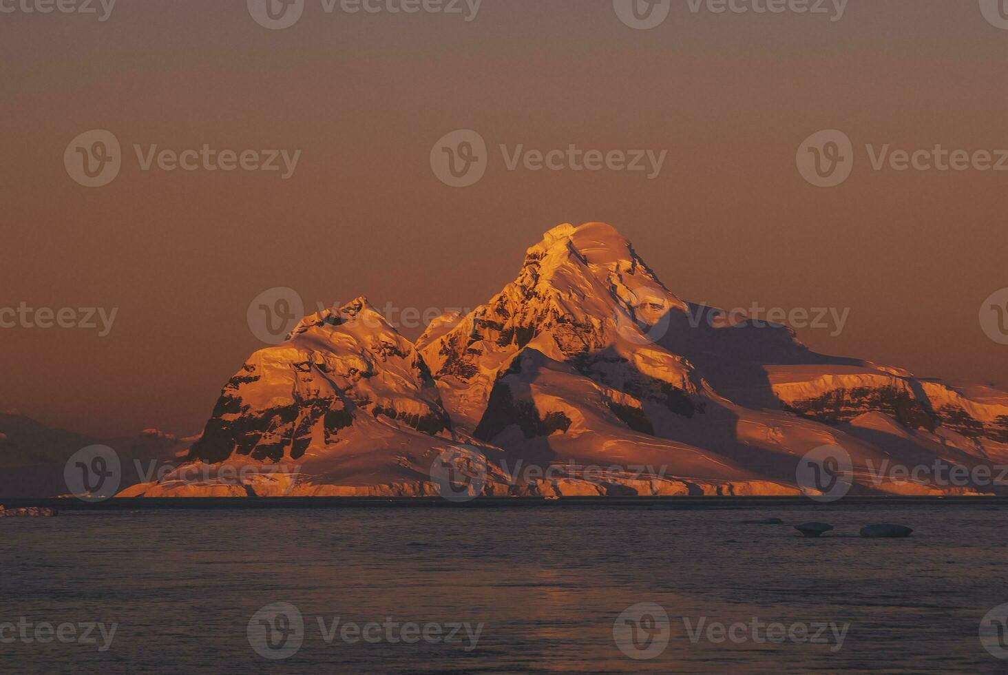 Lemaire strait coastal landscape, mountains and icebergs, Antarctic Peninsula, Antartica. photo