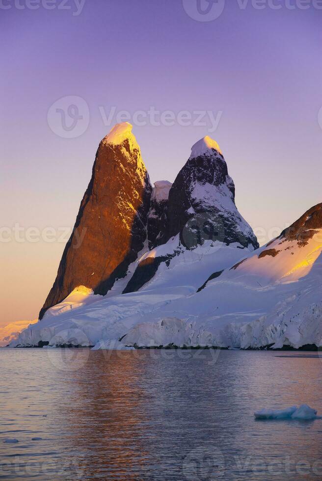 Lemaire strait coastal landscape, mountains and icebergs, Antarctic Peninsula, Antartica. photo