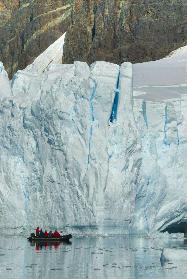 Tourists observing a glacier on the Antarctica, Paradise bay, Antartic Peninsula. photo