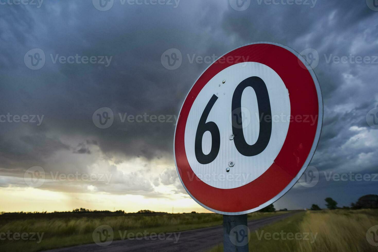 Maximum speed road sign with a stormy sky background, La Pampa province, Patagonia, Argentina. photo