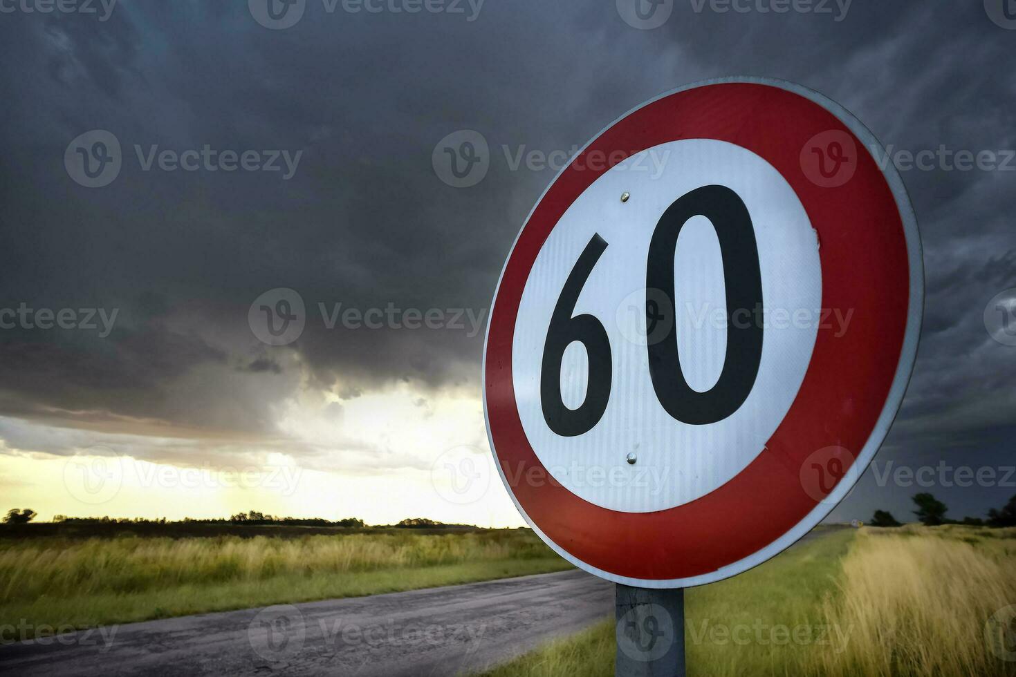 Maximum speed road sign with a stormy sky background, La Pampa province, Patagonia, Argentina. photo