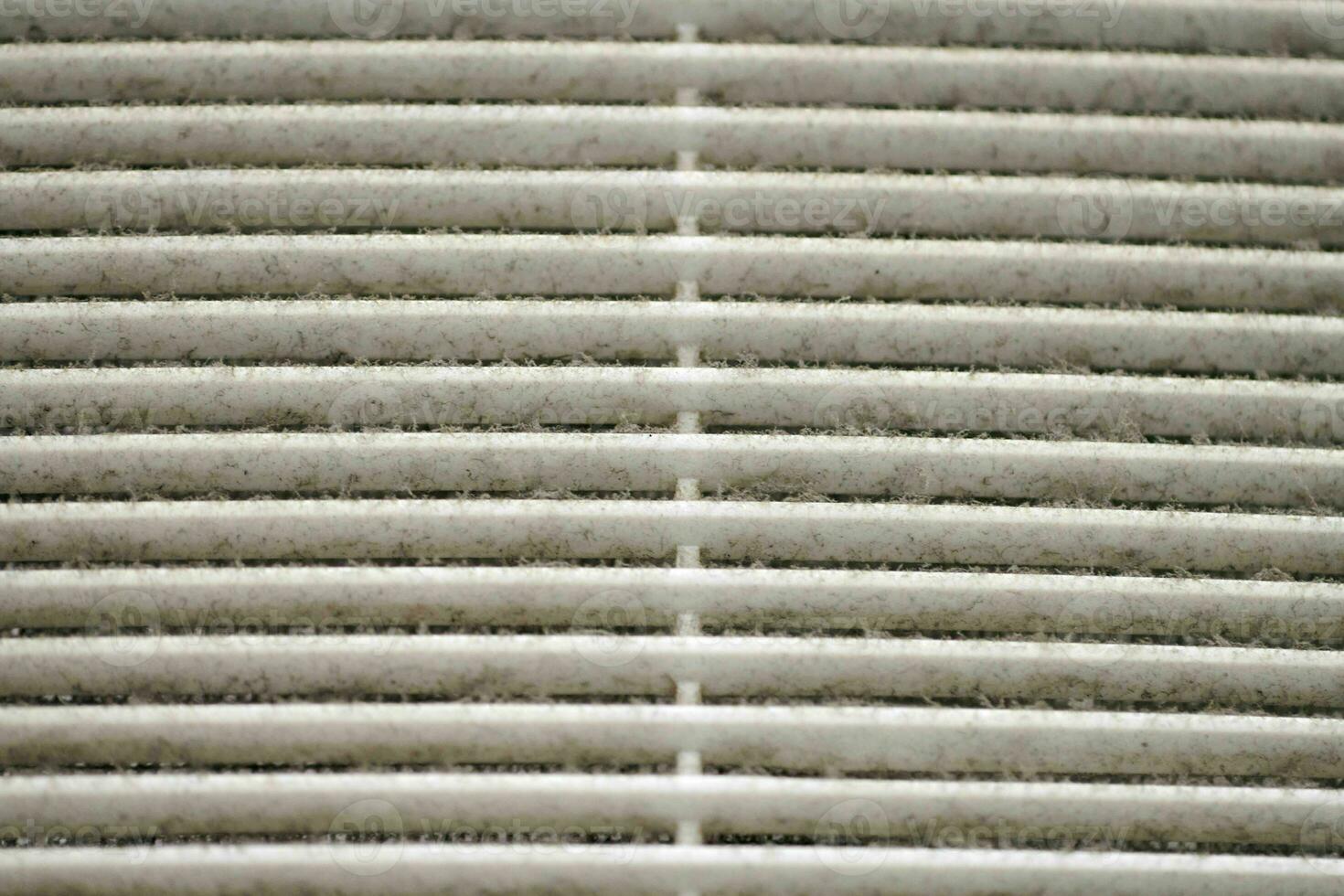 Dirty air ventilation grill of HVAC with clogged filter. photo