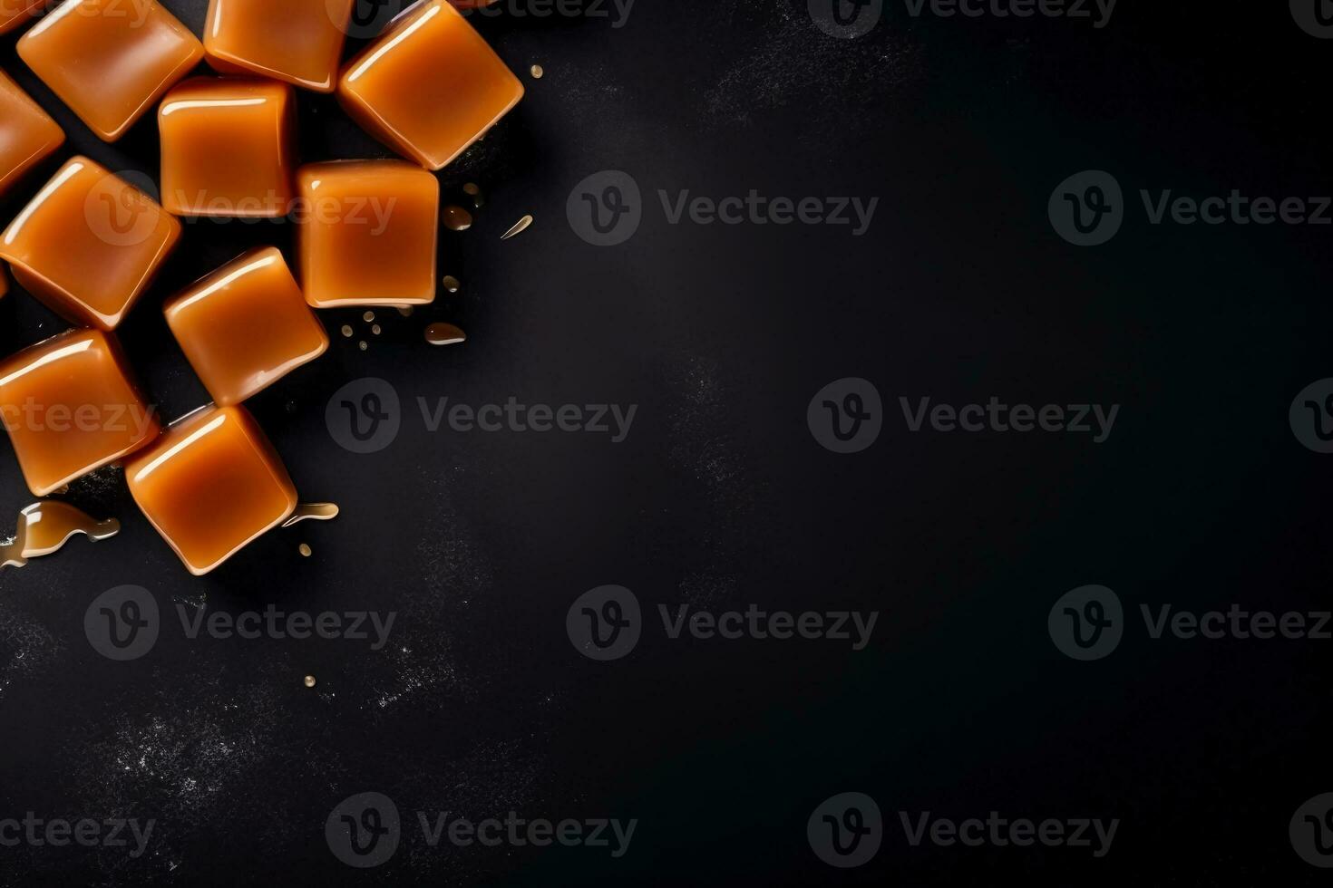 Delicious caramels dark background with empty space for text photo