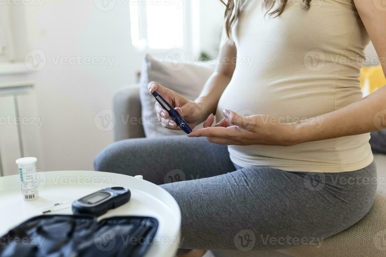Test Blood Glucose For Diabetes in Pregnant Woman With Glucometer. One red drop of blood on the finger ready to measure sugar level. Close up of male finger with blood drop and test stripe photo