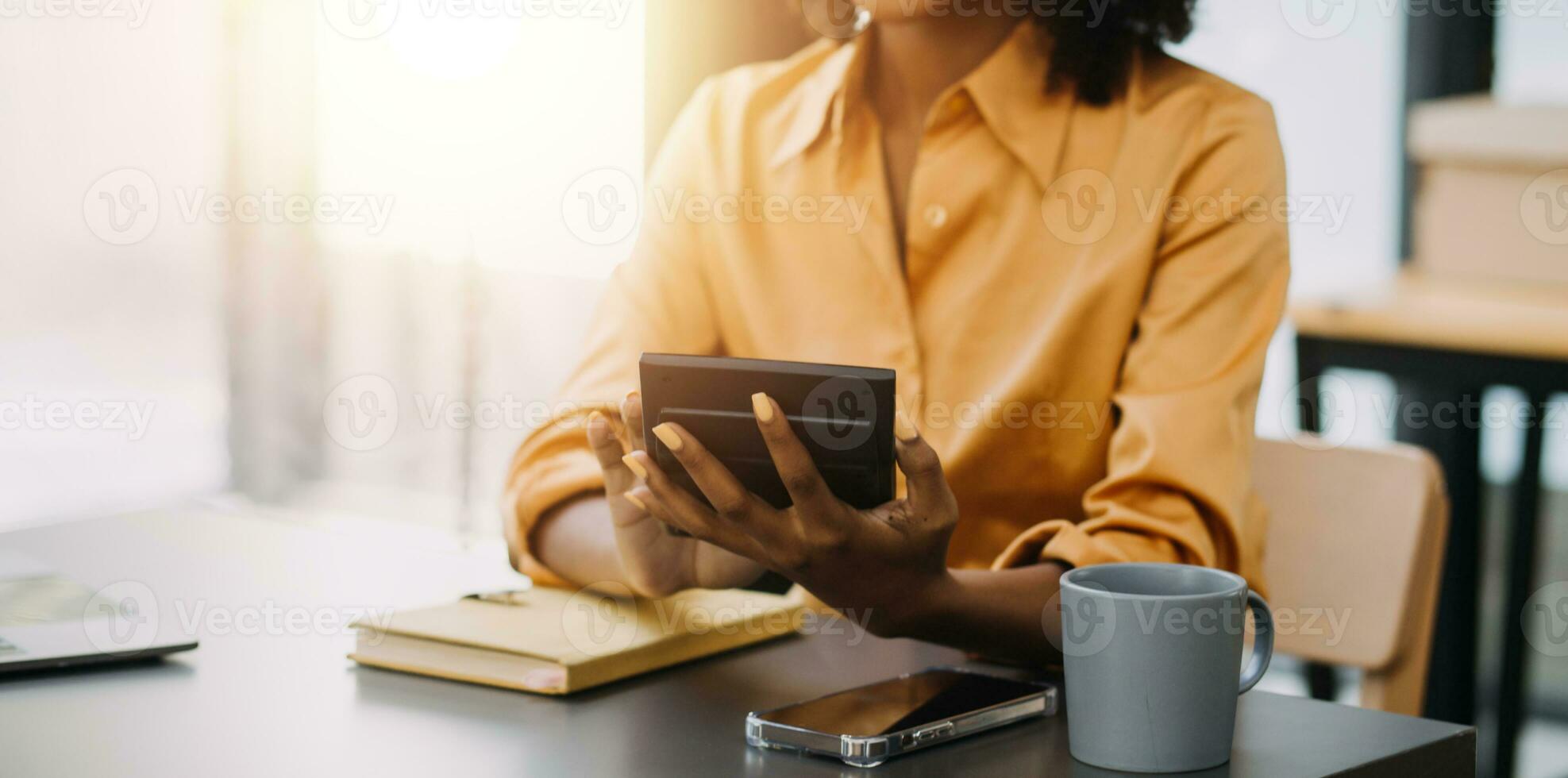 Asian Business woman using calculator and laptop for doing math finance on an office desk, tax, report, accounting, statistics, and analytical research concept photo