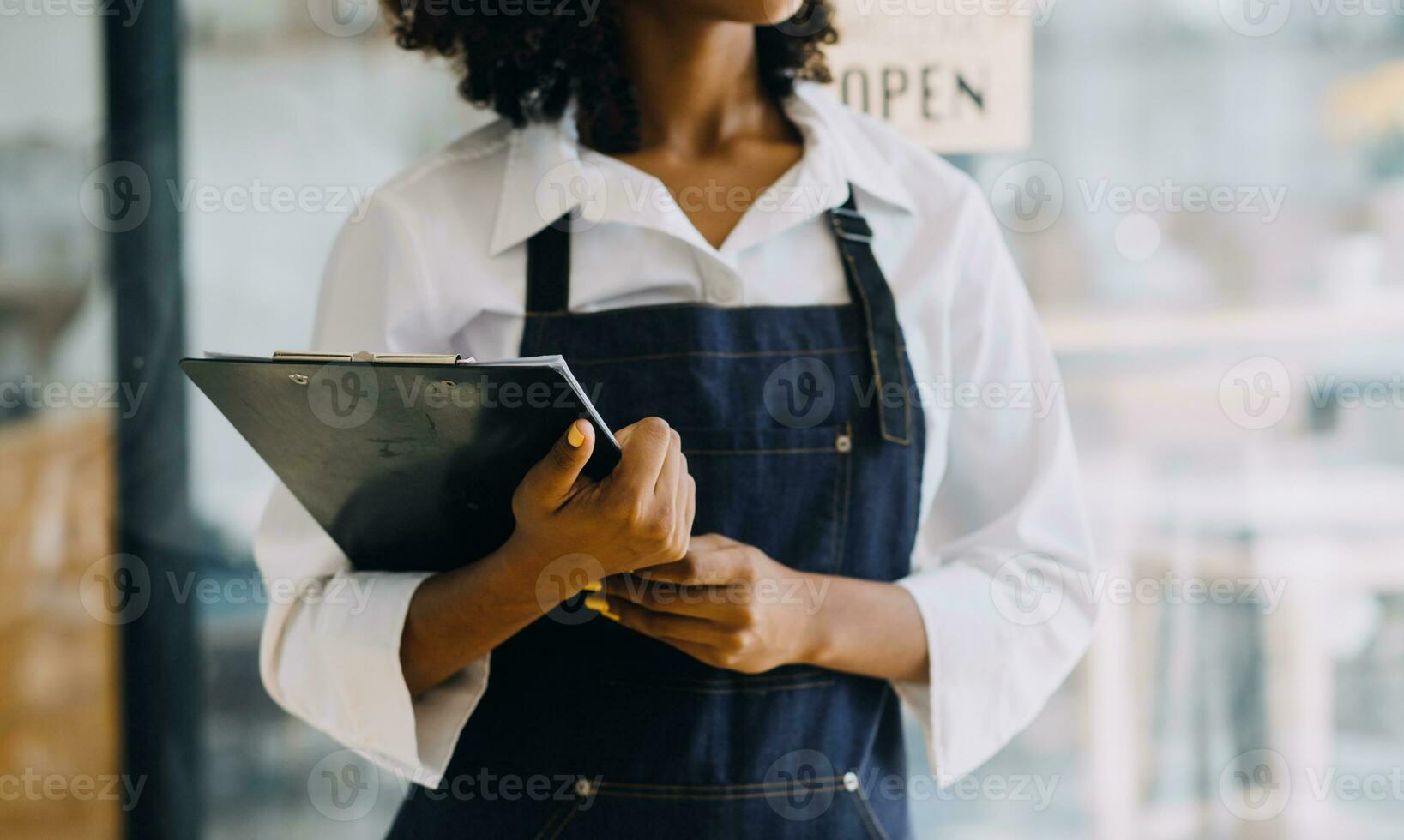 Startup successful small business owner sme beauty girl stand with tablet smartphone in coffee shop restaurant. Portrait of asian tan woman barista cafe owner. SME entrepreneur seller business concept photo