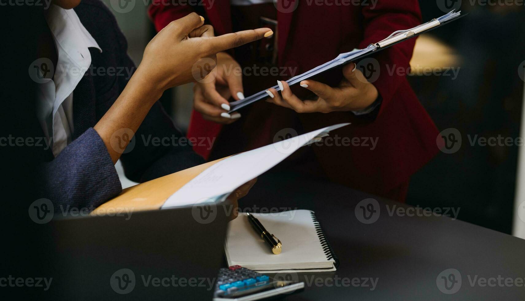 Asian Business woman using calculator and laptop for doing math finance on an office desk, tax, report, accounting, statistics, and analytical research concept photo