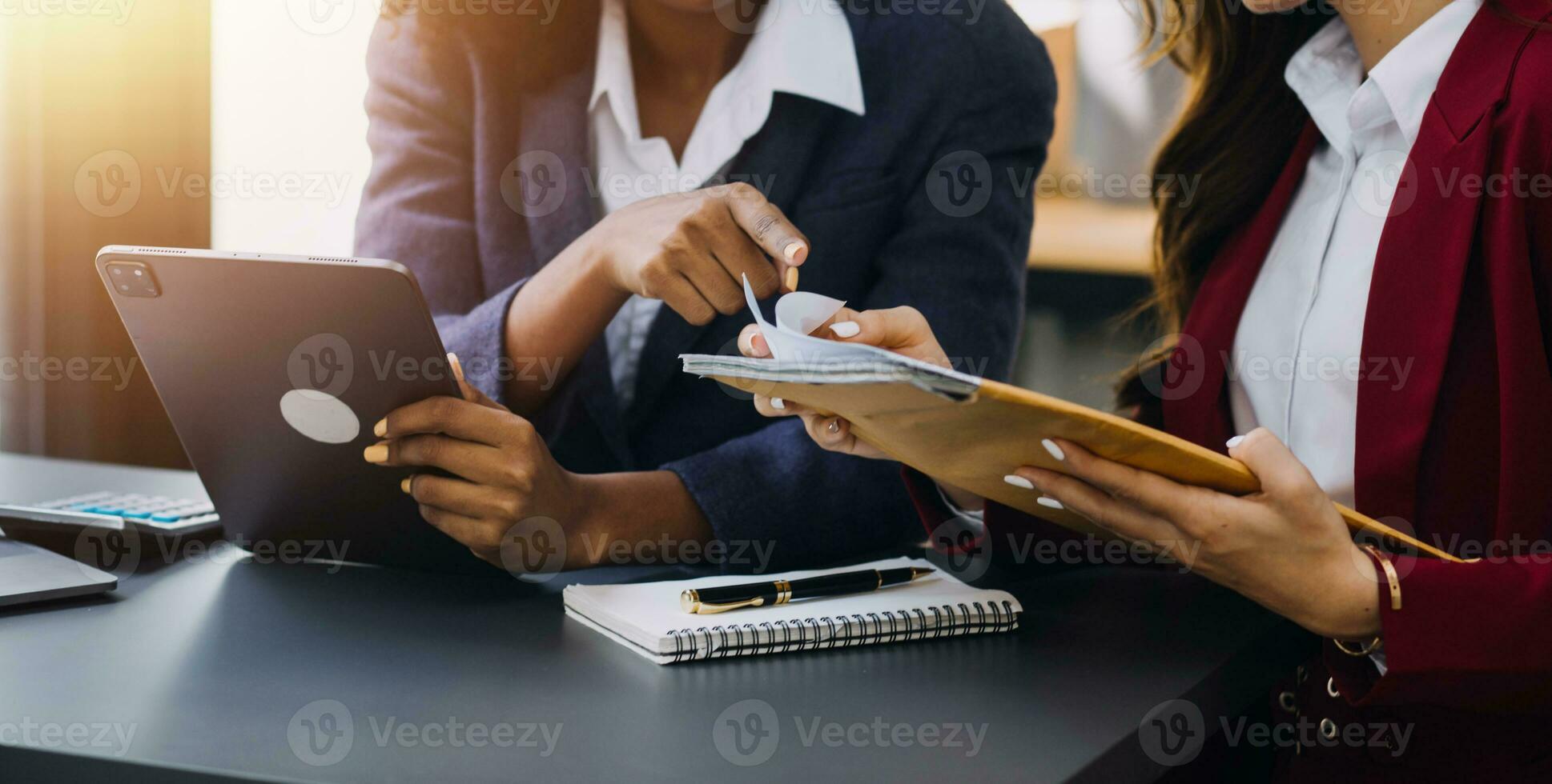 Asian Business woman using calculator and laptop for doing math finance on an office desk, tax, report, accounting, statistics, and analytical research concept photo