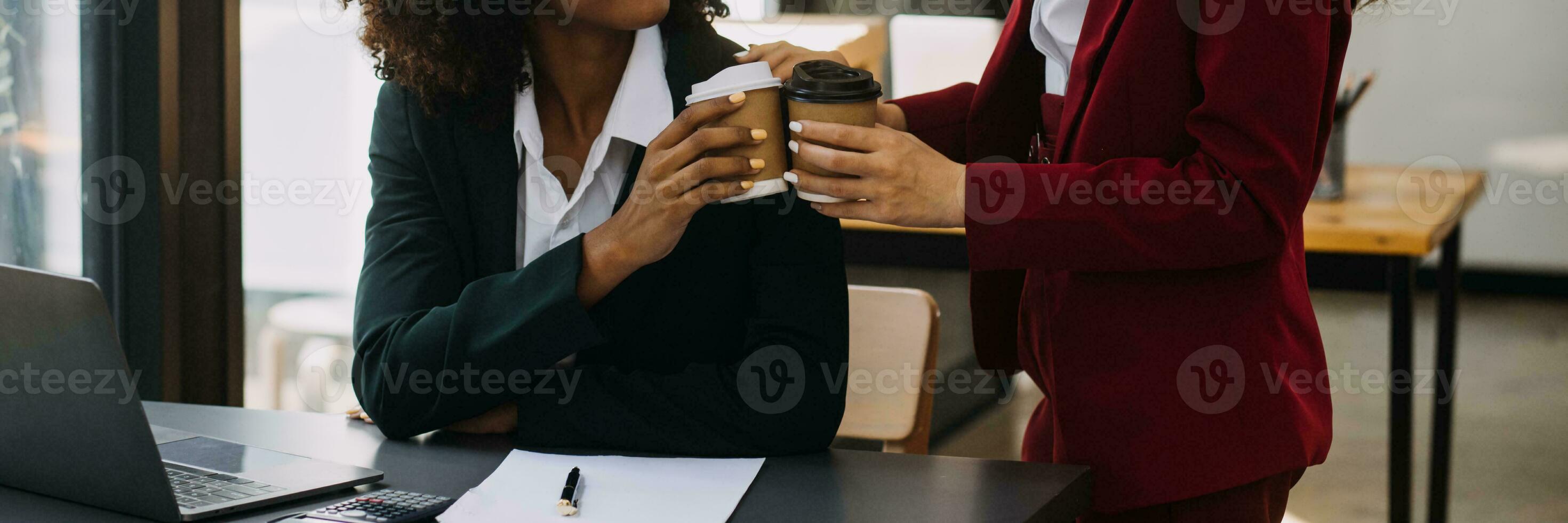 Asian Business woman using calculator and laptop for doing math finance on an office desk, tax, report, accounting, statistics, and analytical research concept photo
