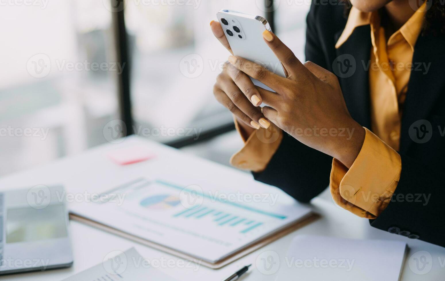 Asian Business woman using calculator and laptop for doing math finance on an office desk, tax, report, accounting, statistics, and analytical research concept photo