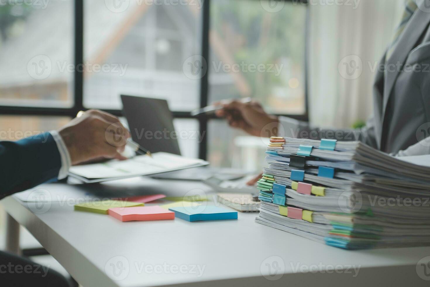 Financial analysts analyze business financial reports on a digital tablet planning investment project during a discussion at a meeting of corporate showing the results of their successful teamwork. photo
