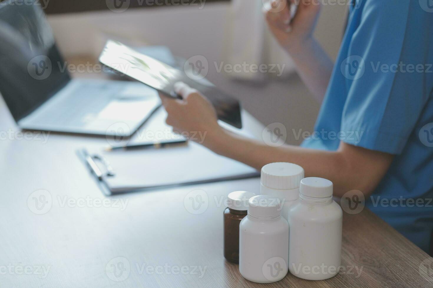 Close-up of stethoscope and paper on background of doctor and patient hands photo