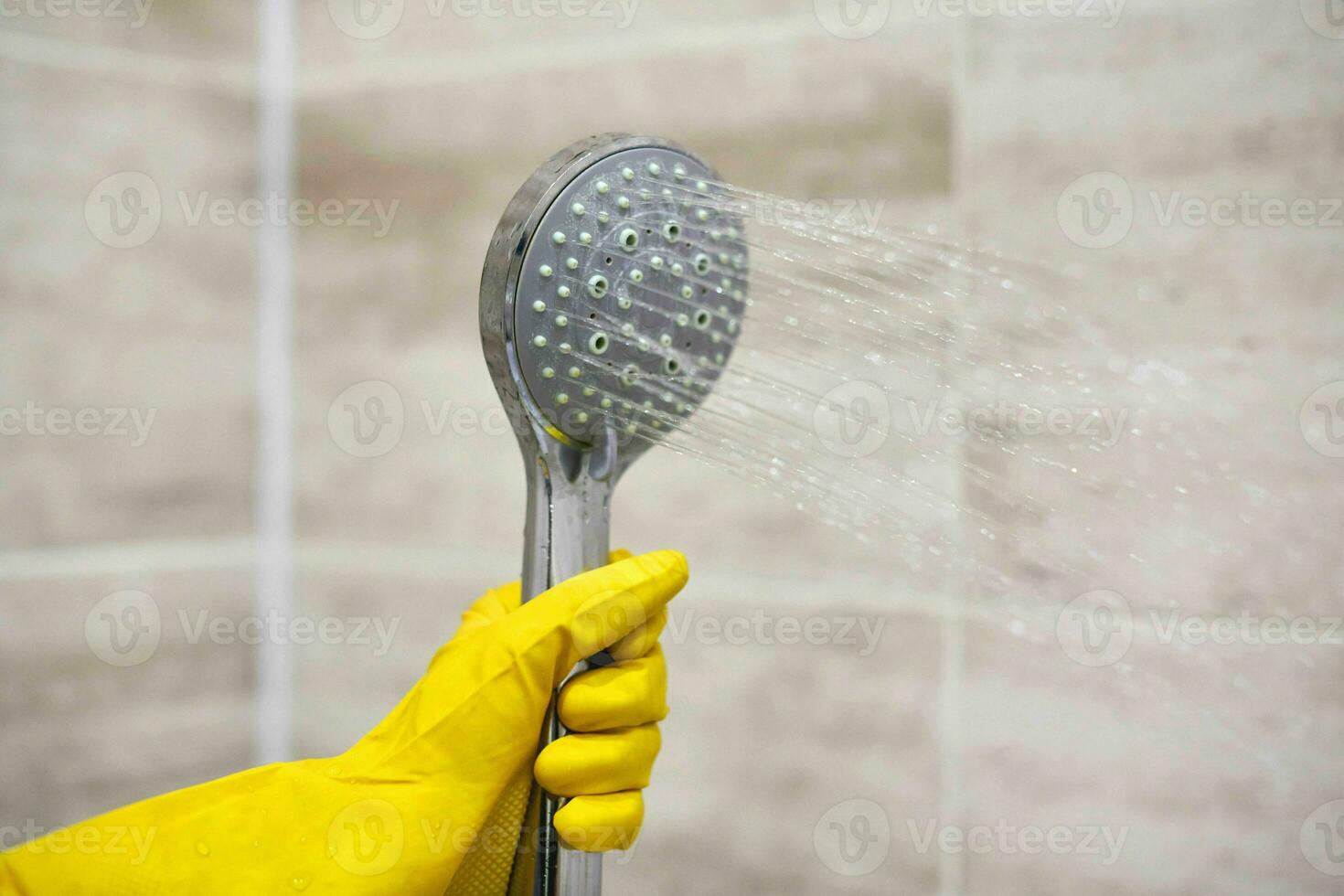 Female hand holds shower head with pouring water, copy space photo