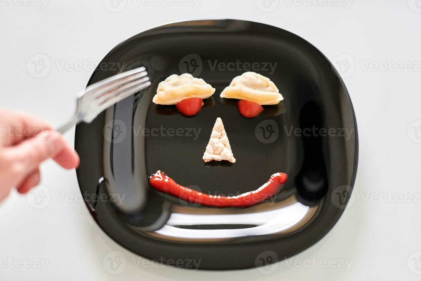 Funny food face, dumpling and ketchup photo