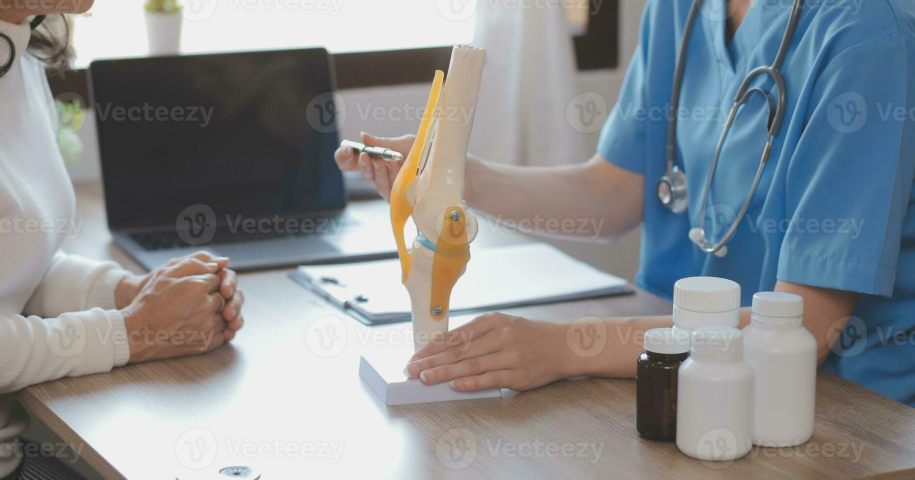 Close-up of stethoscope and paper on background of doctor and patient hands photo