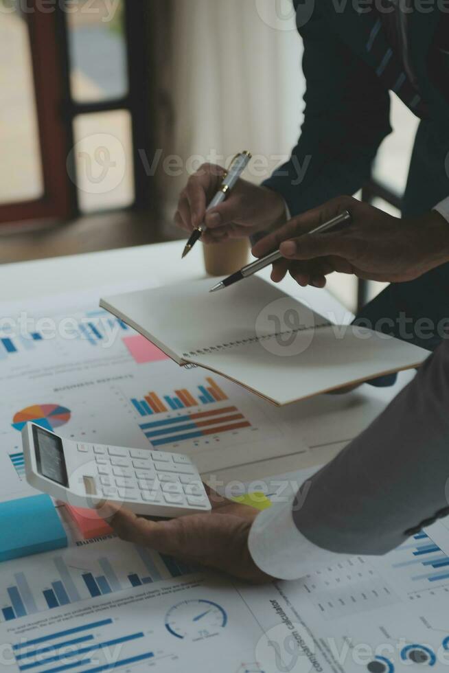 Financial analysts analyze business financial reports on a digital tablet planning investment project during a discussion at a meeting of corporate showing the results of their successful teamwork. photo