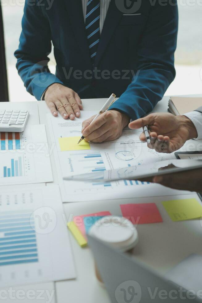 Financial analysts analyze business financial reports on a digital tablet planning investment project during a discussion at a meeting of corporate showing the results of their successful teamwork. photo