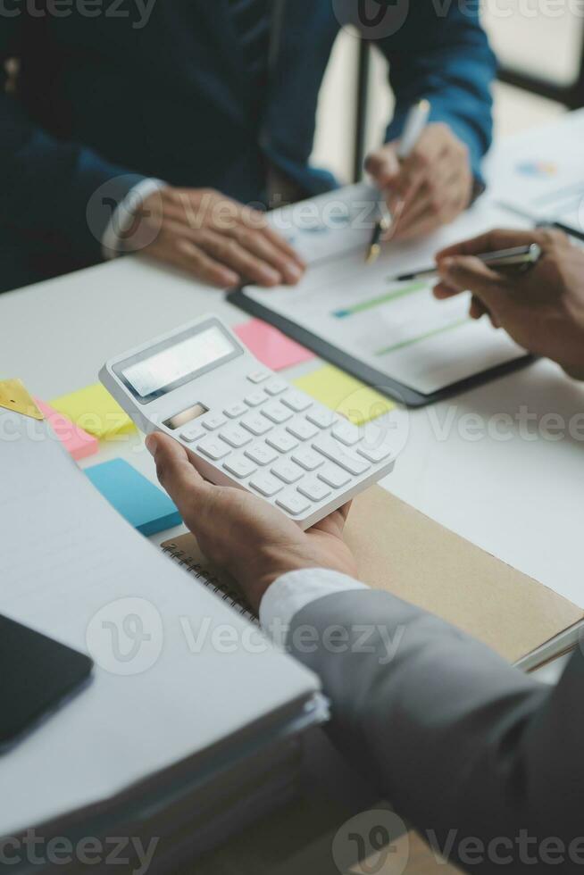 Financial analysts analyze business financial reports on a digital tablet planning investment project during a discussion at a meeting of corporate showing the results of their successful teamwork. photo