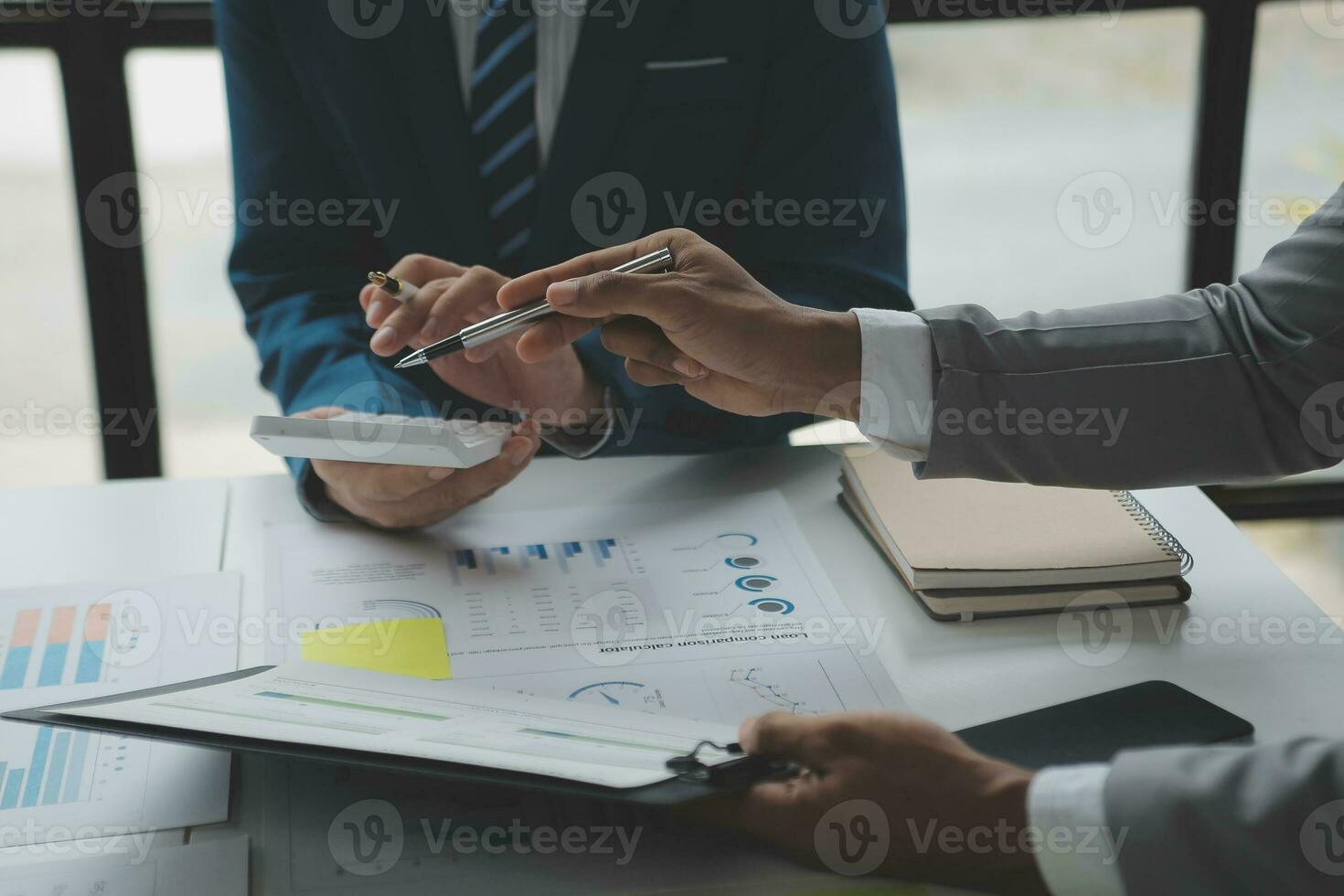 Financial analysts analyze business financial reports on a digital tablet planning investment project during a discussion at a meeting of corporate showing the results of their successful teamwork. photo