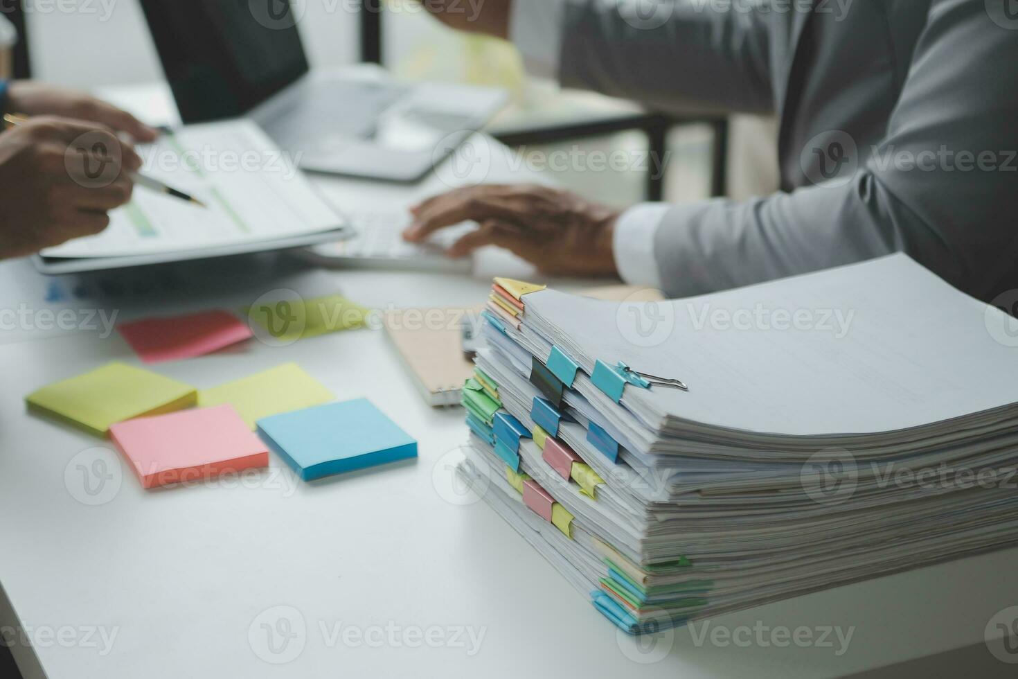 Financial analysts analyze business financial reports on a digital tablet planning investment project during a discussion at a meeting of corporate showing the results of their successful teamwork. photo