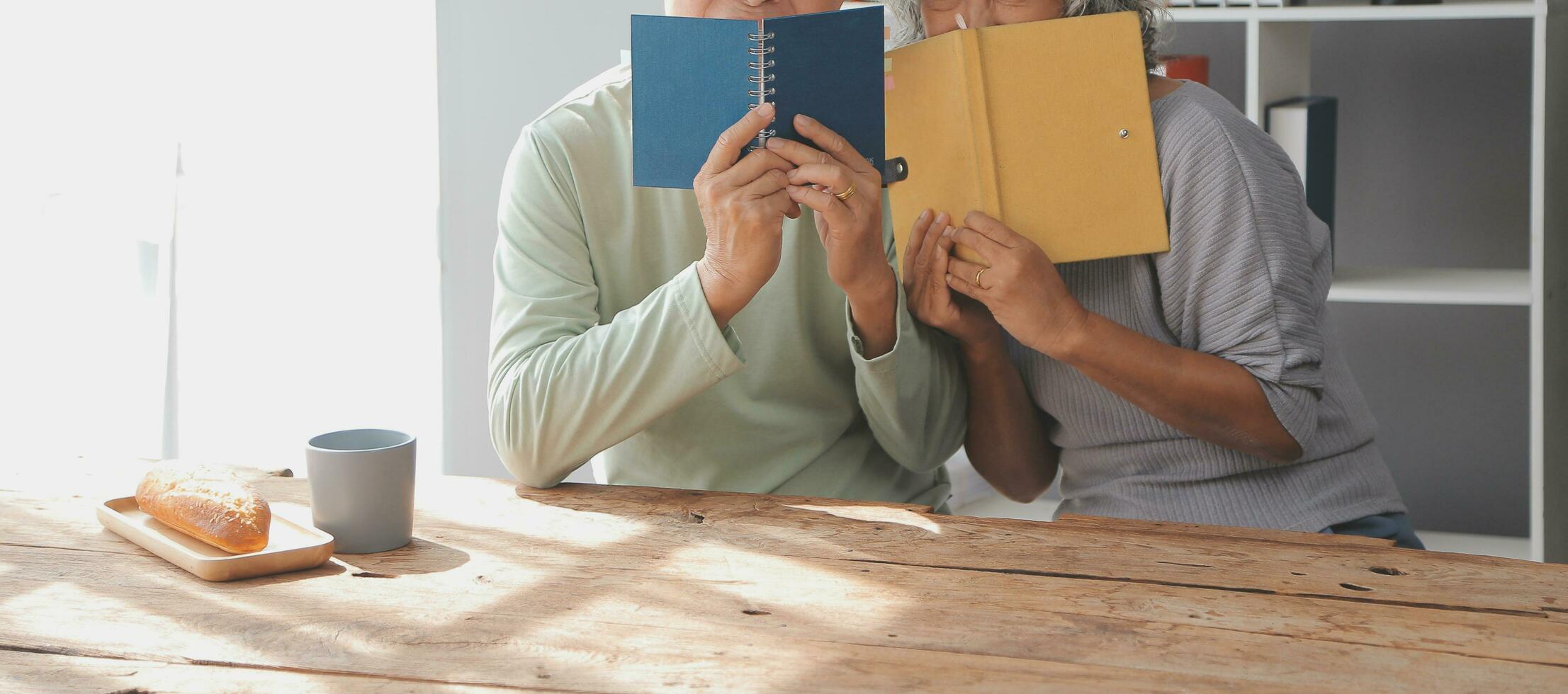 Happy mature couple using laptop at home photo