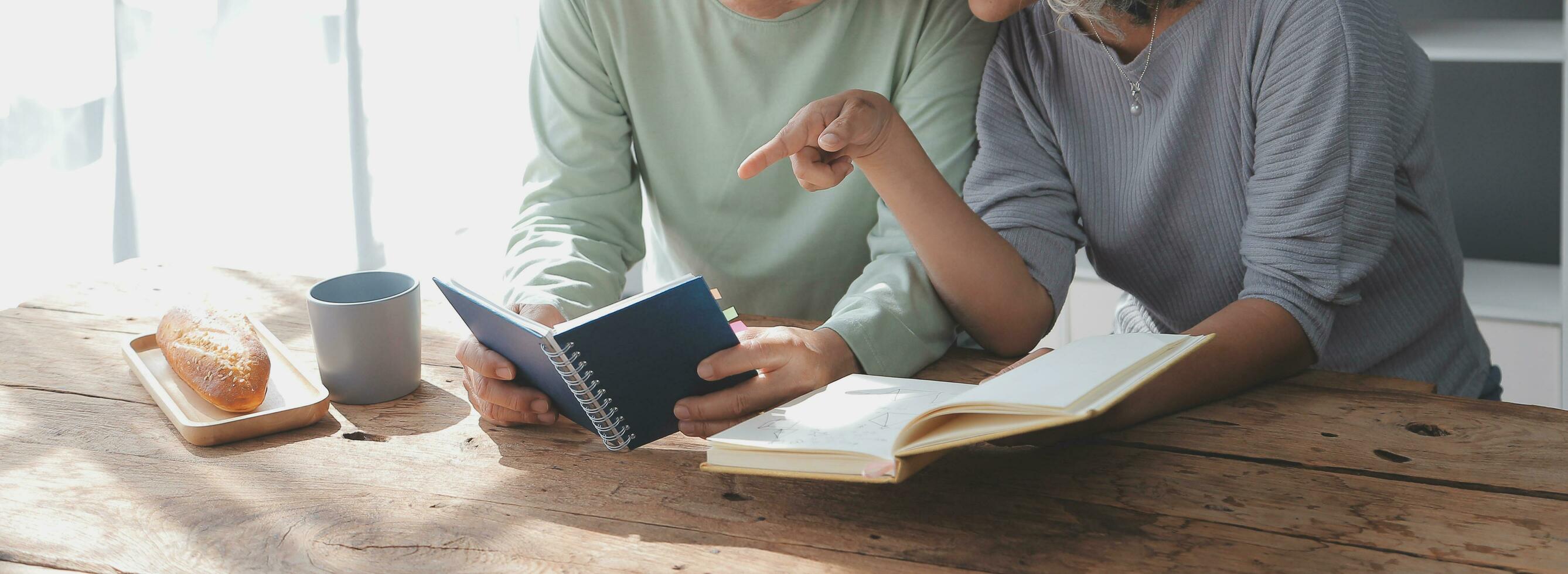 Embraced mature couple surfing the Internet on laptop at home photo