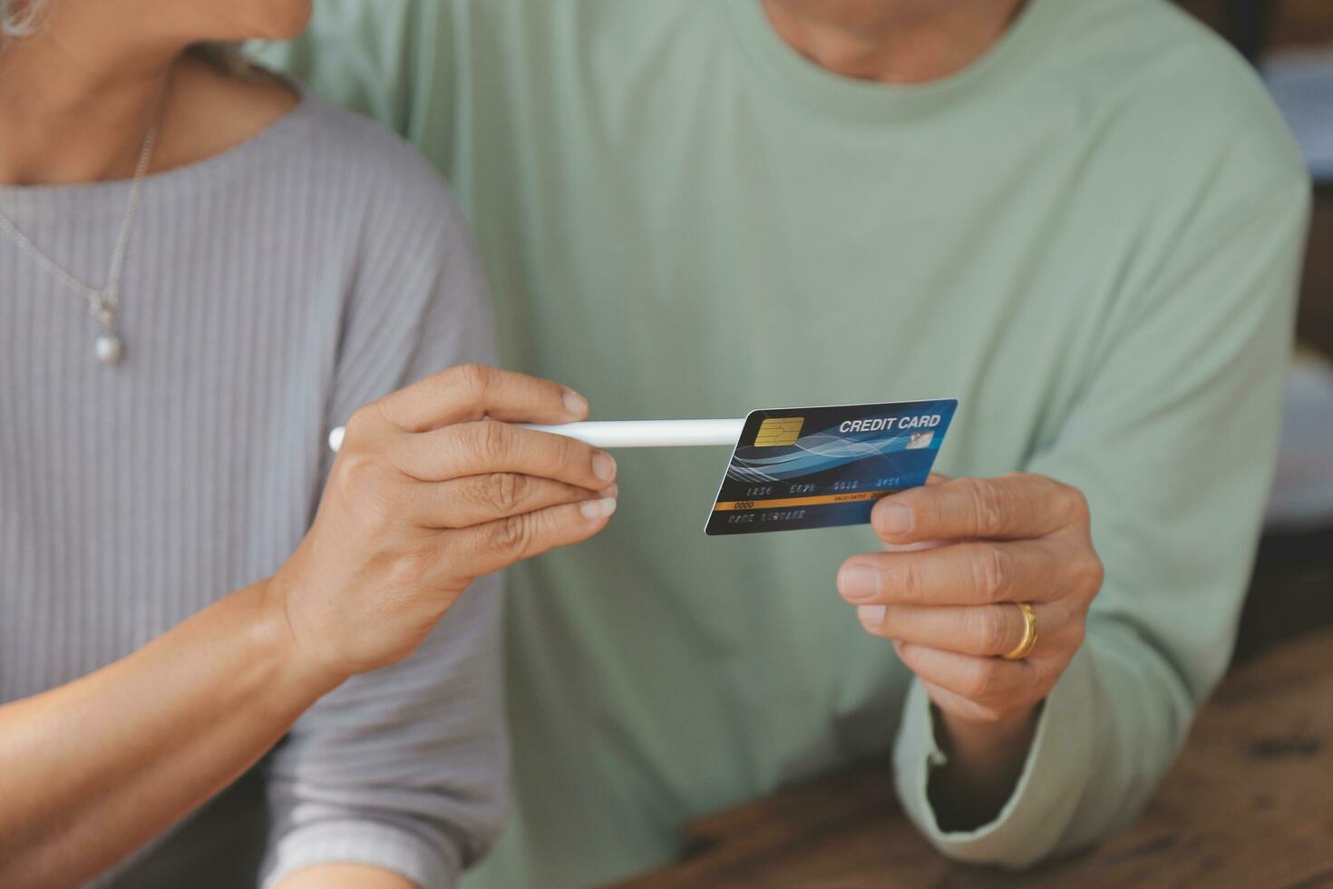 Shocked aged couple become victims of online fraud using credit card phone to pay for goods order service online on suspicious website. Frustrated older spouses overspending money at internet shopping photo