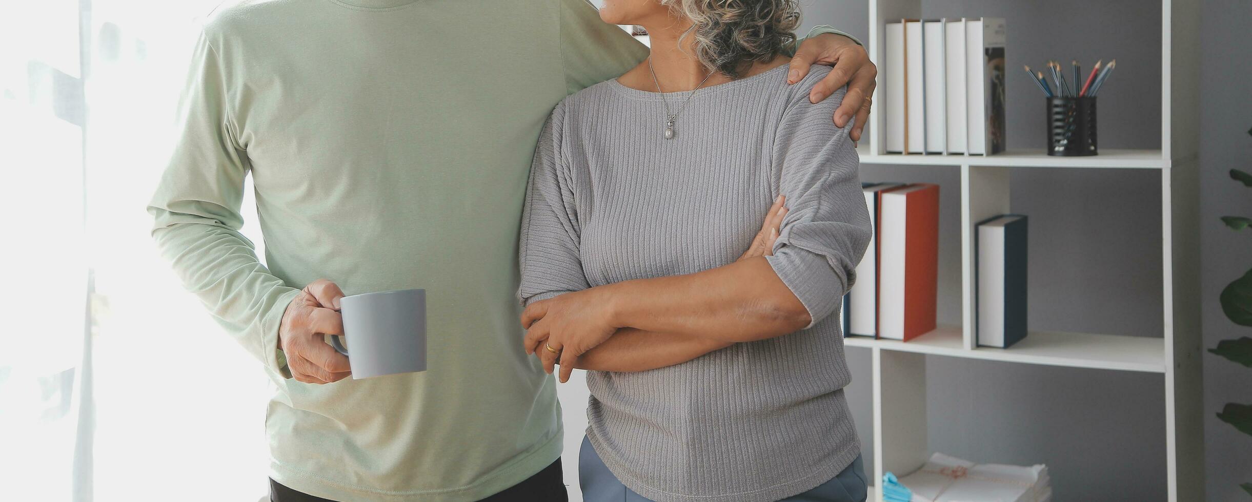 Happy mature couple using laptop at home photo