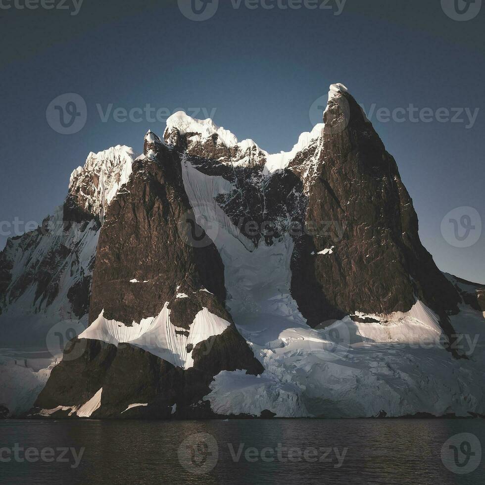 Lemaire strait coastal landscape, mountains and icebergs, Antarctic Peninsula, Antartica. photo