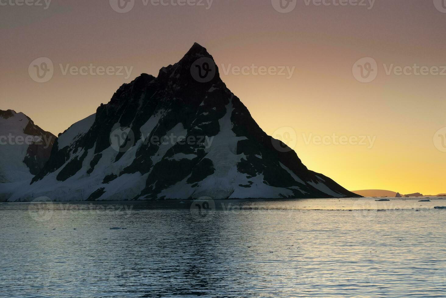 Lemaire strait coast, mountains and icebergs, Antartica photo