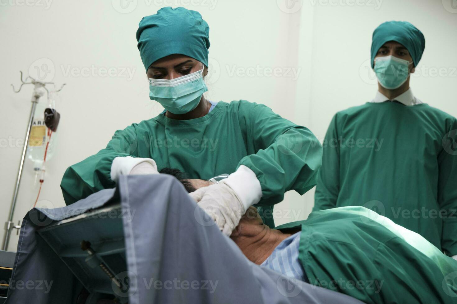 ICU female doctor and practitioners removed male patient's hat and ventilator after failed surgery resuscitation and passed away in hospital emergency room, life rescue with medical operation. photo