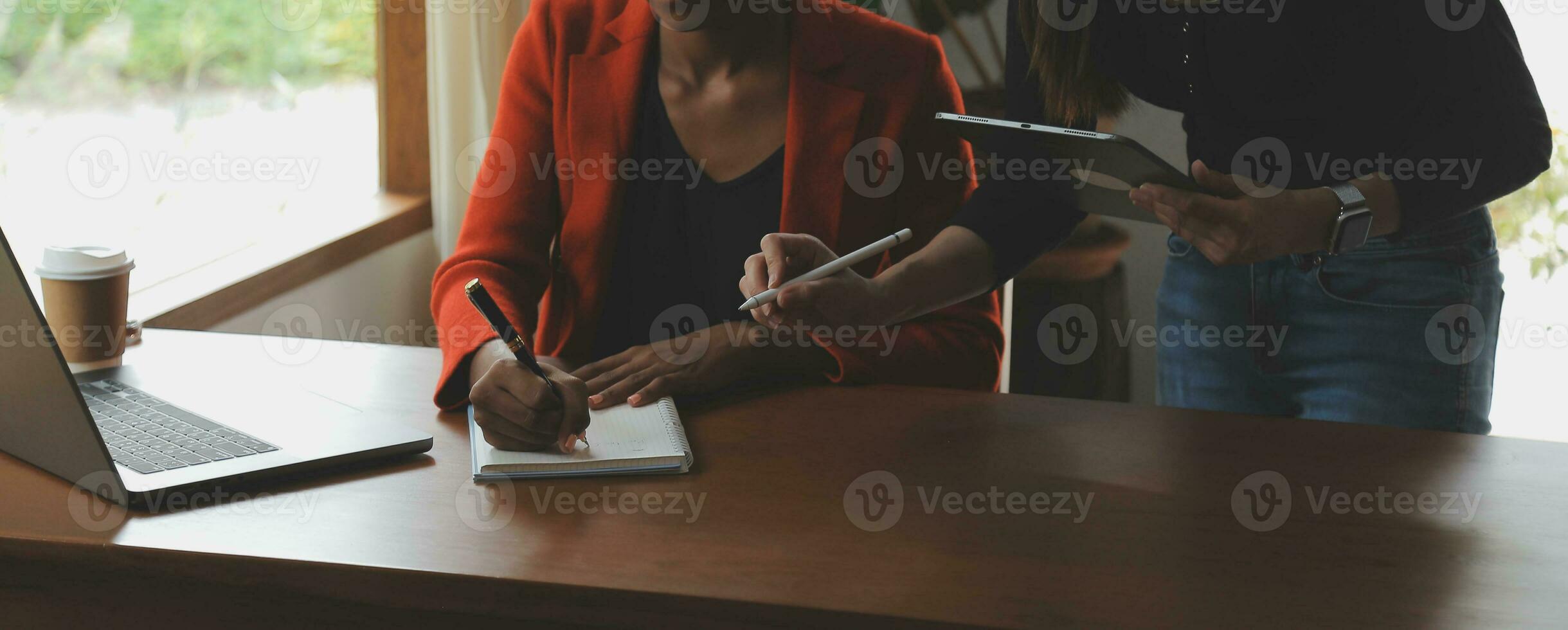 Creative Asian young woman working on laptop in her studio photo