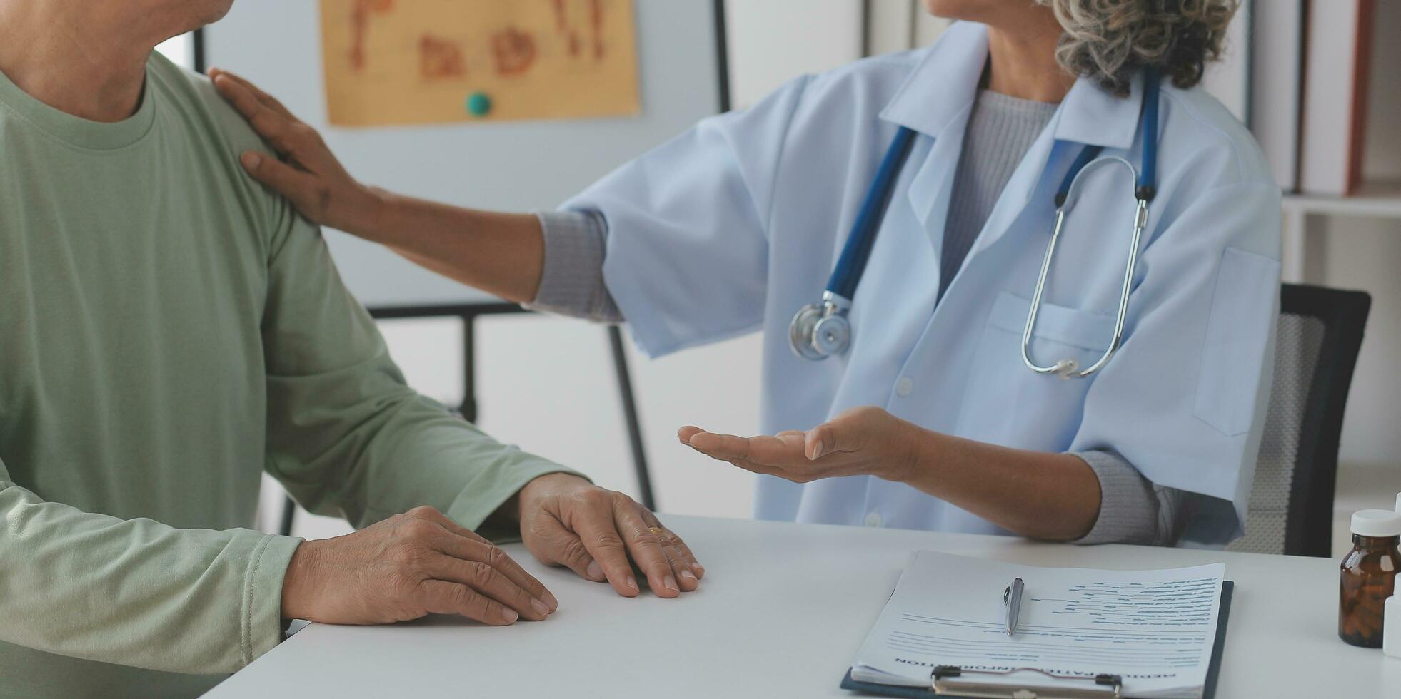 Doctor giving hope. Close up shot of young female physician leaning forward to smiling elderly lady patient holding her hand in palms. Woman caretaker in white coat supporting encouraging old person photo