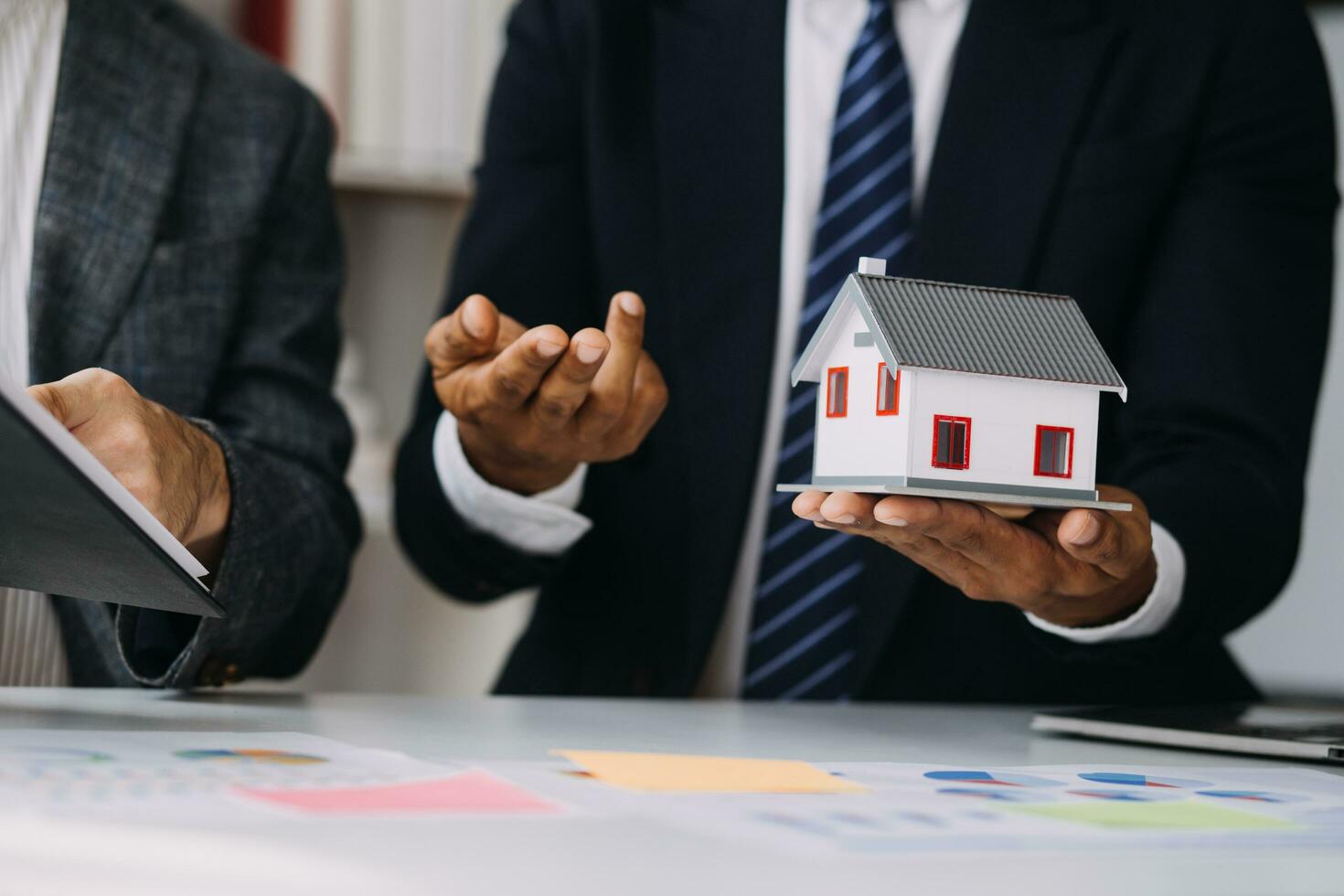 Image of business partners handshaking over business objects on workplace photo