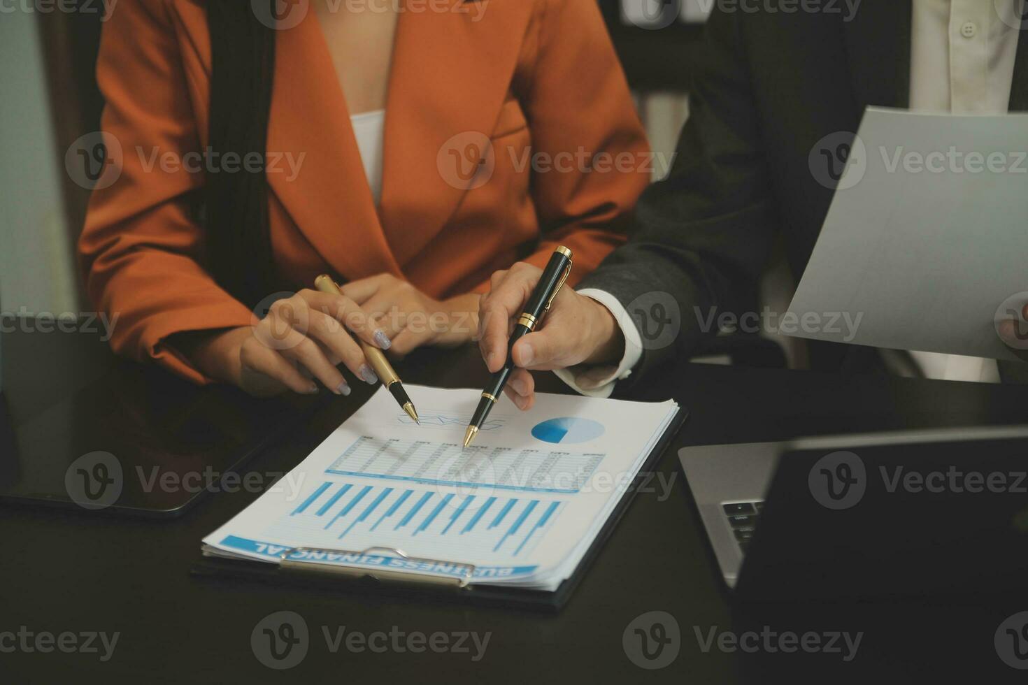 Close up Business woman using calculator and laptop for do math finance on wooden desk, tax, accounting, statistics and analytical research concept photo