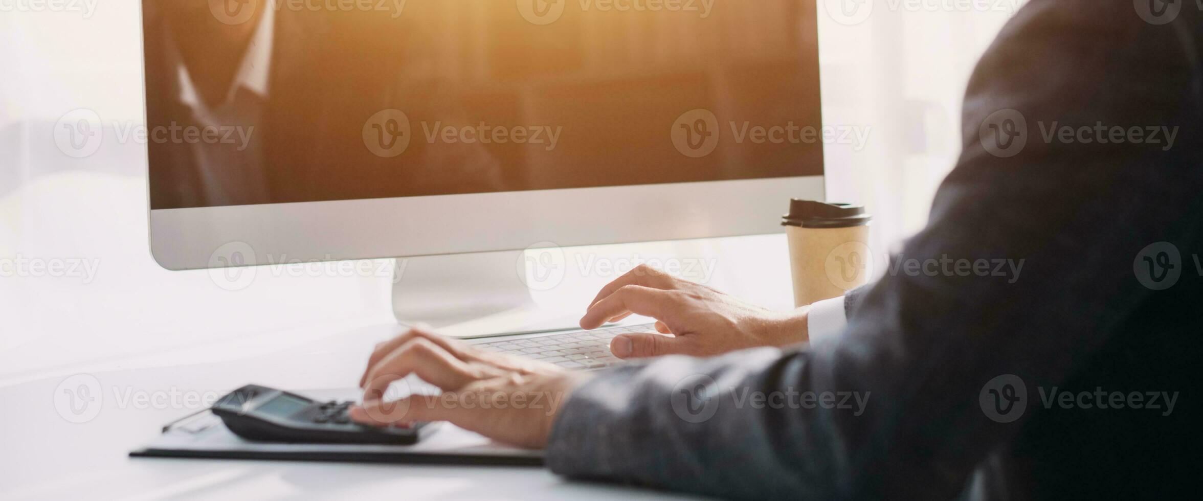 Businessman working on a laptop computer to document management online documentation database digital file storage system software records keeping database technology file access doc sharing. photo