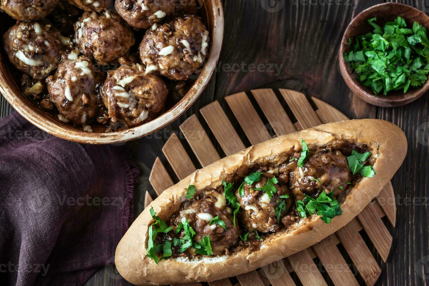 Hot dog bun stuffed with meatballs photo