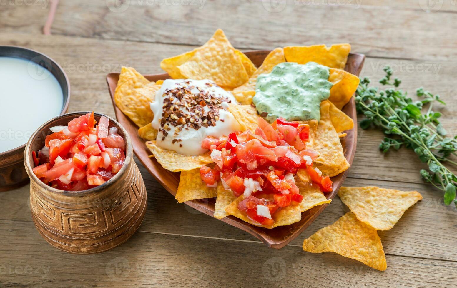 Cheese nachos with different types of sauce photo