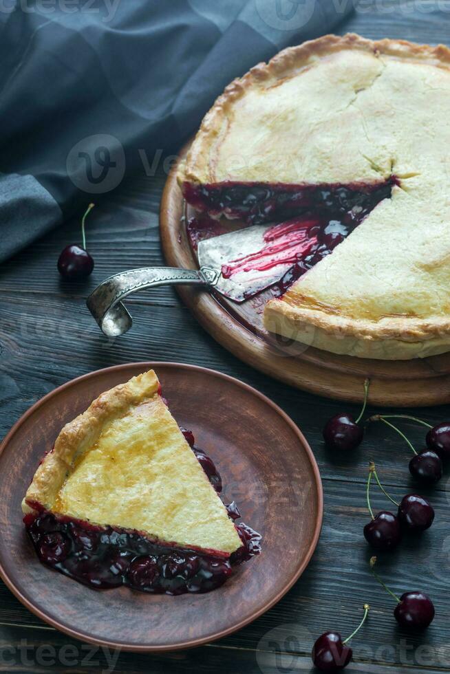 Cherry pie on the wooden background photo