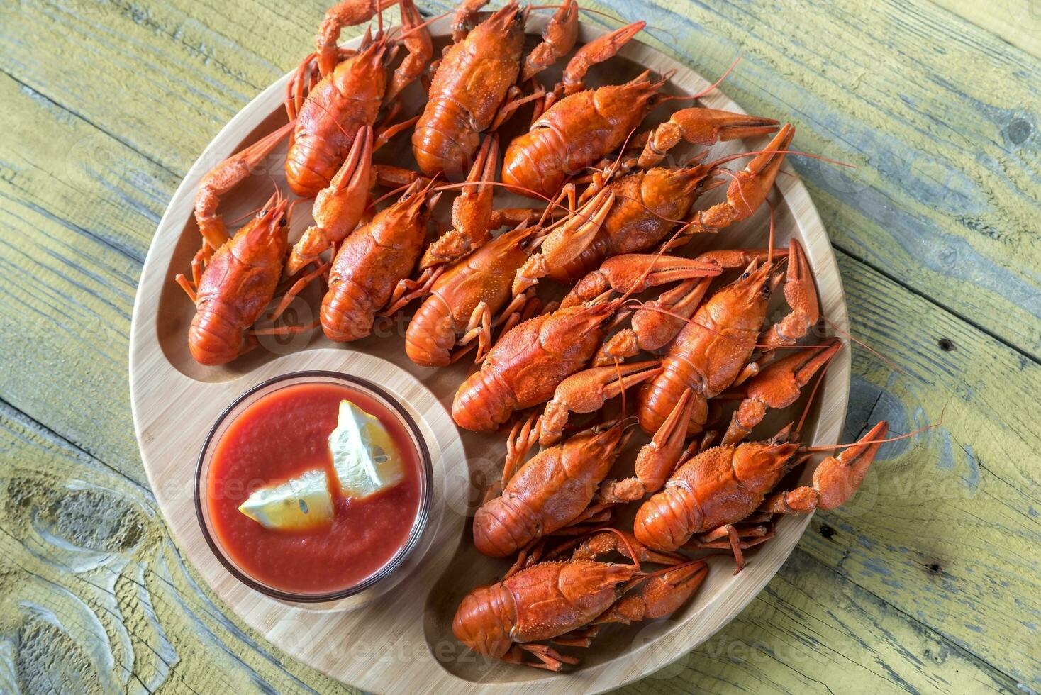 Dish of boiled crayfish with sauce photo