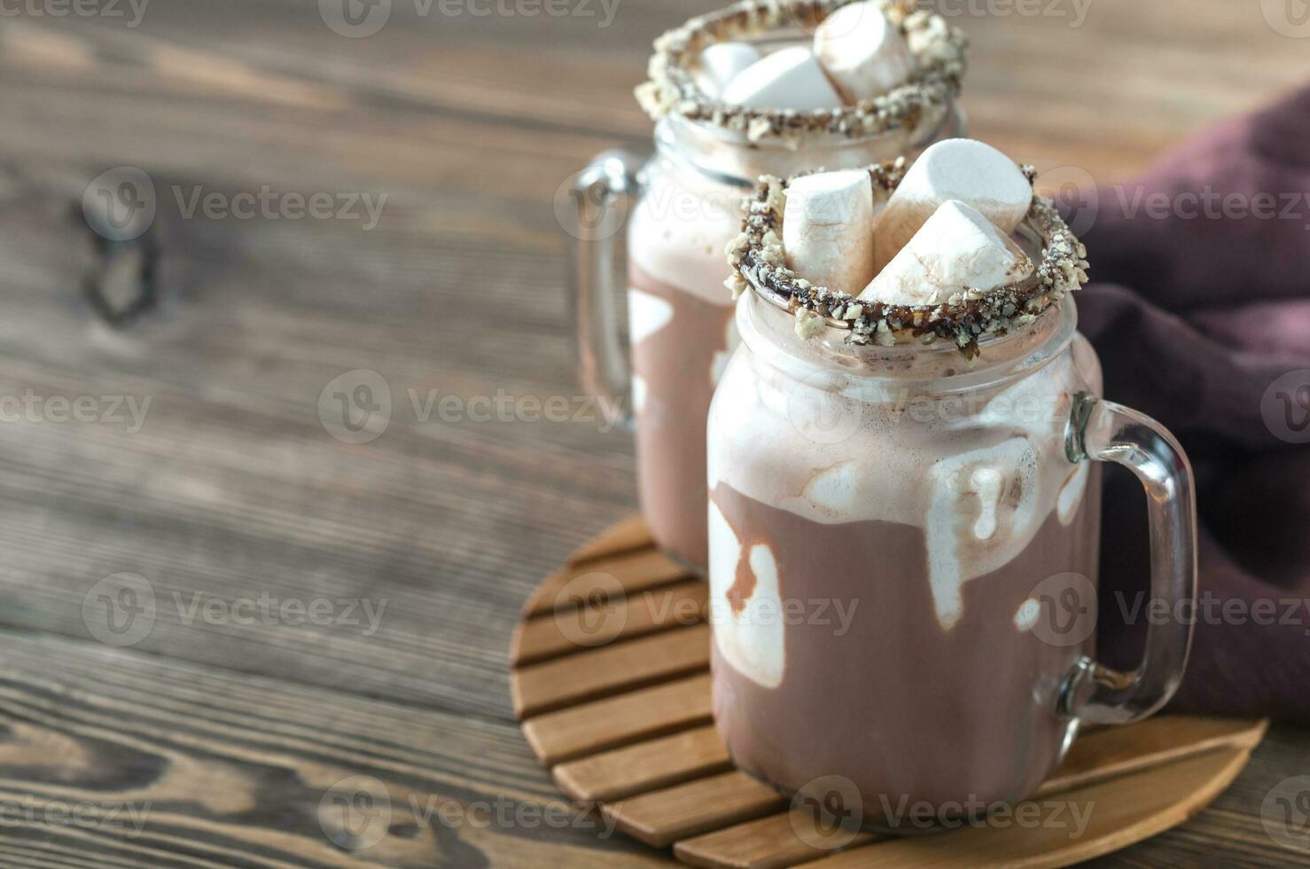 Two mugs of hot chocolate with marshmallows photo