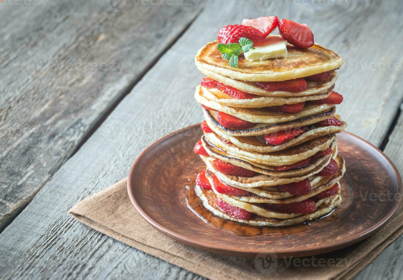 Stack of pancakes with fresh strawberries photo