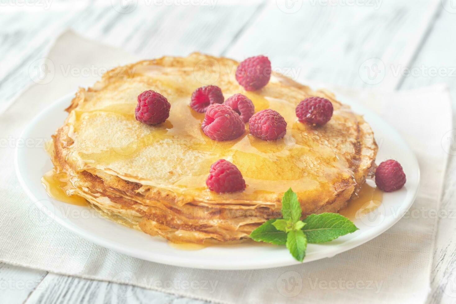 Stack of crepes with raspberries photo