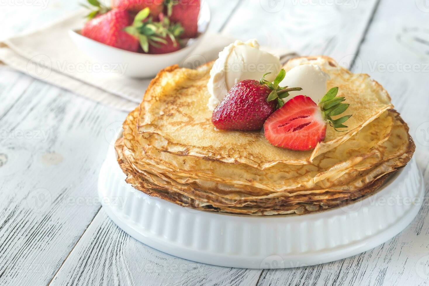 Crepes with cream cheese and fresh strawberries photo