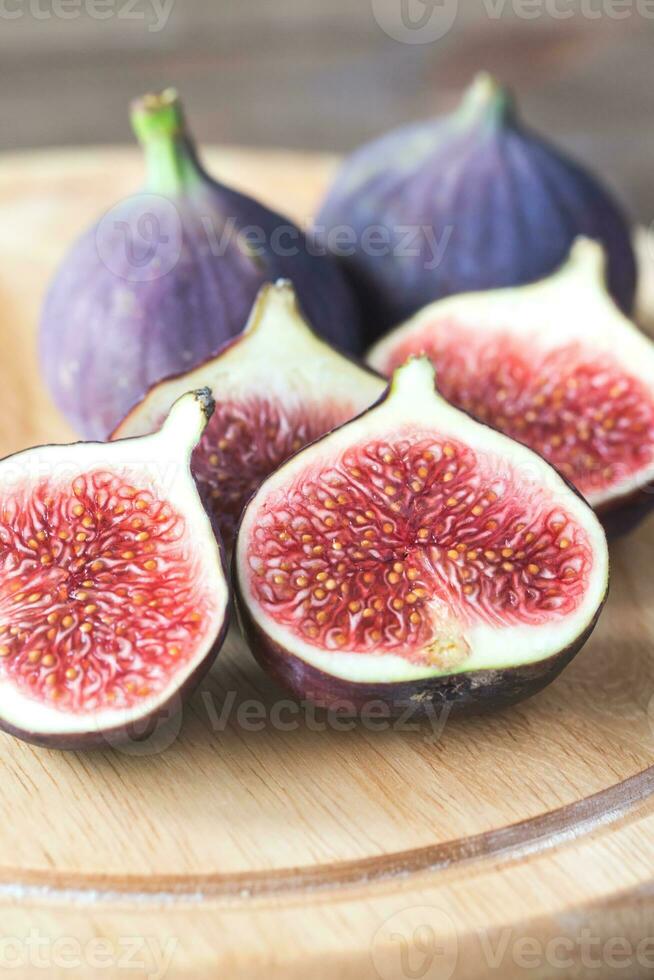 Ripe figs on the wooden board photo