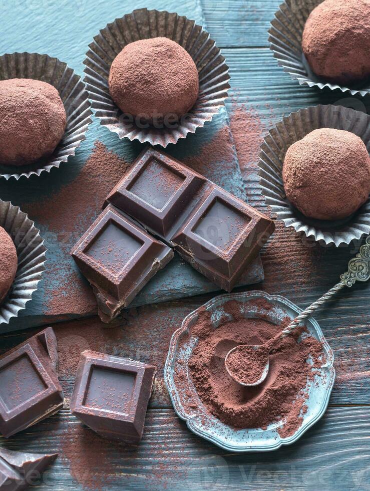 Rum balls with cocoa powder and chocolate slices photo