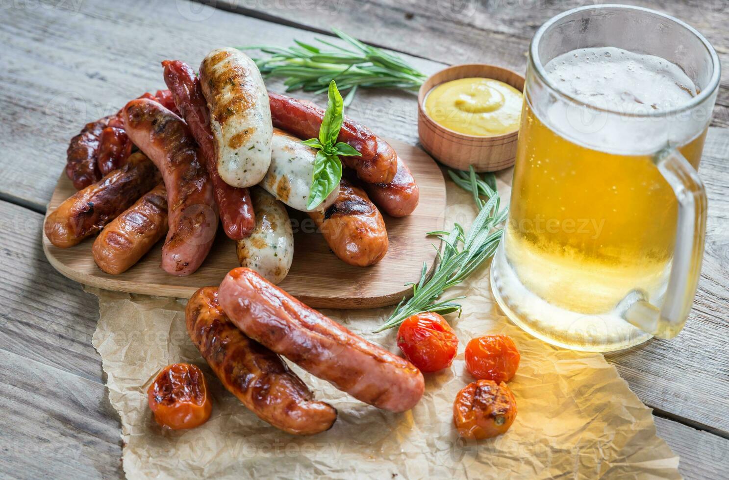 salchichas a la parrilla con un vaso de cerveza foto