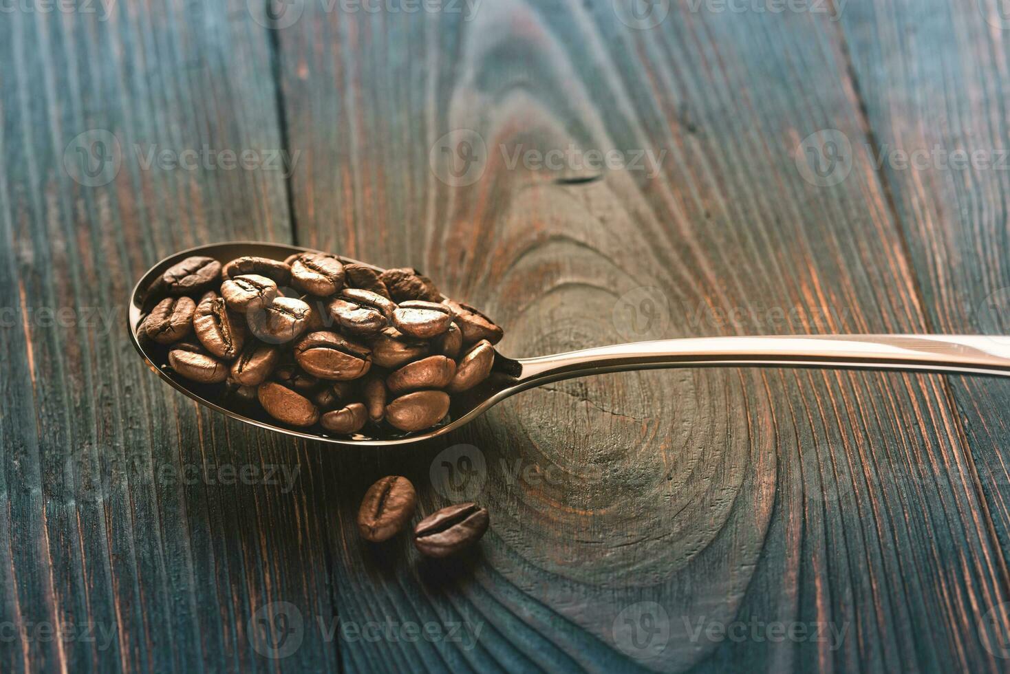 Spoon of coffee beans photo